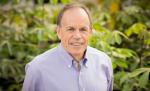 Stephen P. Long portrait in a greenhouse.