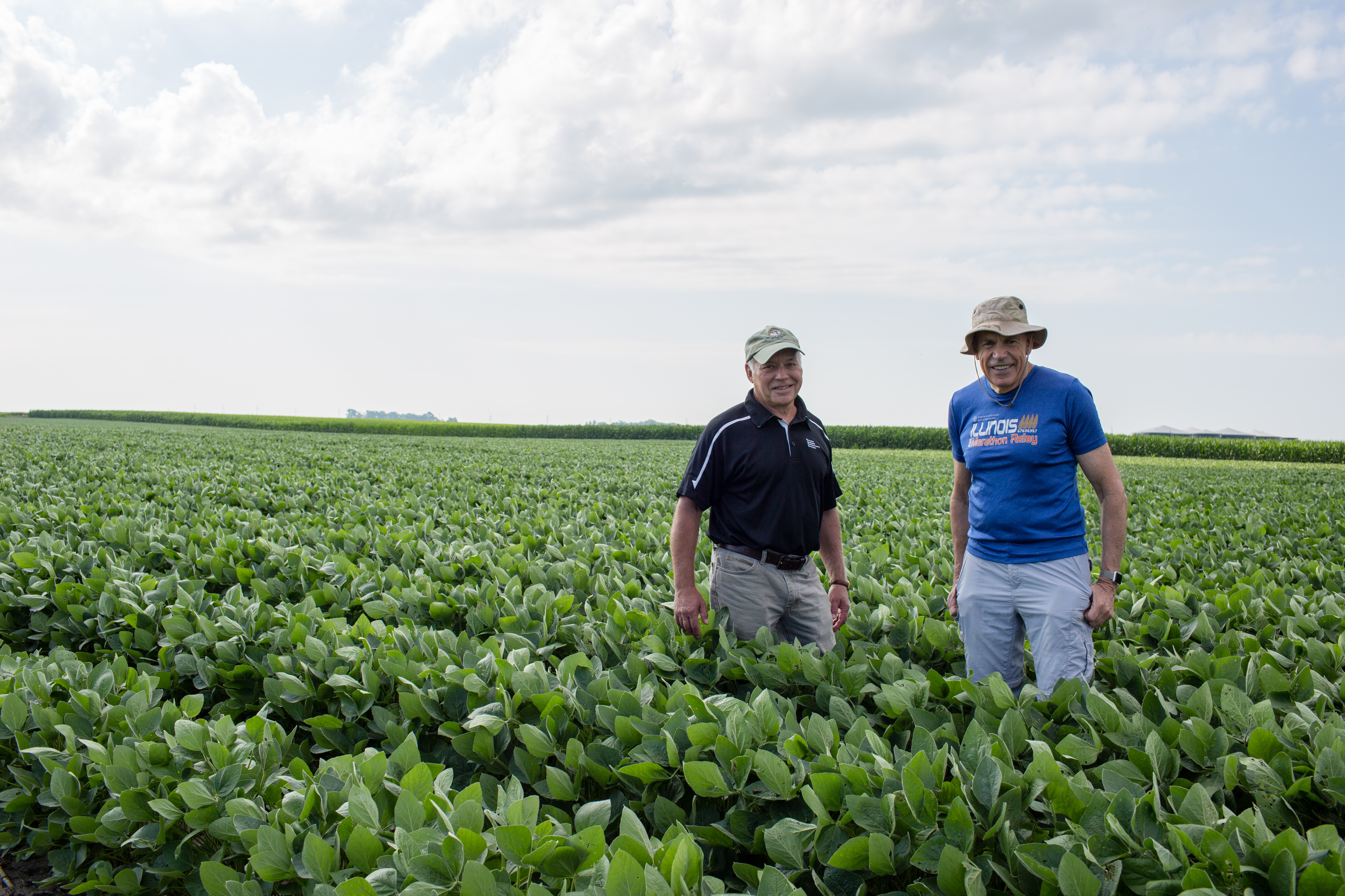 Steve Long and Don Ort stand in soybean field
